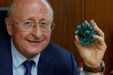 Alexander Gintsburg, director of the Gamaleya National Research Center for Epidemiology and Microbiology, poses for a picture with a crystal coronavirus figure during an interview with Reuters in Moscow, Russia September 24, 2020. REUTERS/Tatyana Makeyeva