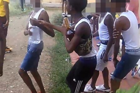  A snapshot from a video that circulated online yesterday, showing a group of children holding and drinking what appeared to be alcoholic beverages.