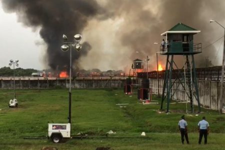 The Lusignan prison dorm engulfed by fire after a riot in July. (Stabroek News file photo)