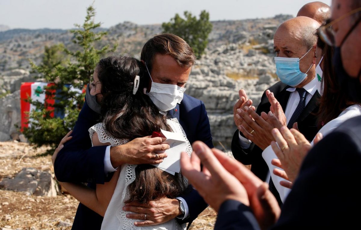 French President Emmanuel Macron hugs blast victim Tamara Tayah as he attends a ceremony to plant a cedar with members of the NGO Jouzour Loubnan in Jaj, near Beirut, Lebanon September 1, 2020. REUTERS/Gonzalo Fuentes/Pool