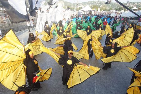 Masqueraders from Peter Minshall presentation of Mas Pieta cross the stage at the Queen’s Park Savannah, on Carnival Tuesday this year
