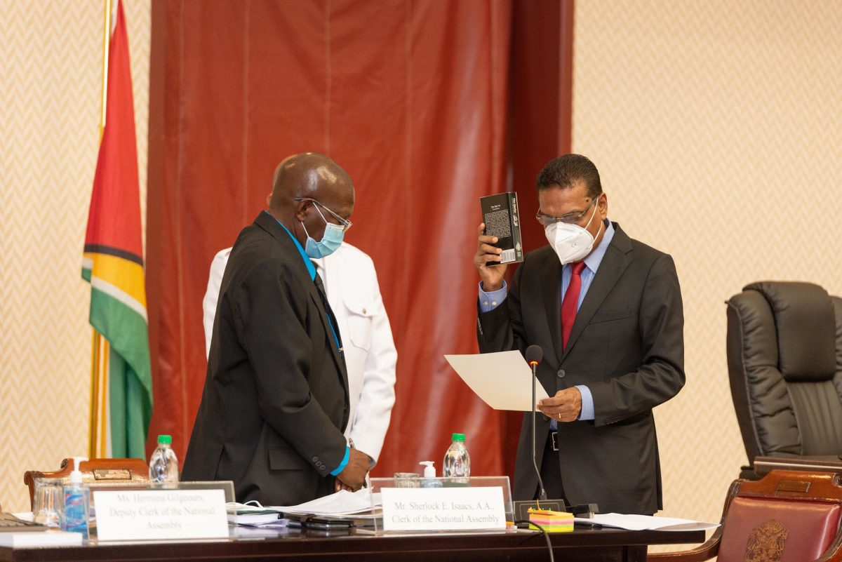 New Speaker Manzoor Nadir (right) taking the oath of office before Clerk Sherlock Isaacs. (DPI photo)