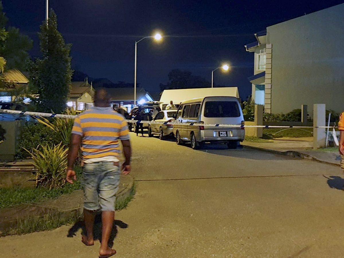 Police officers at the home of murdered prison officer Sherwin Francis  at his home in Fossobianco Drive, Oasis Greens, Chaguanas last night where he was killed.