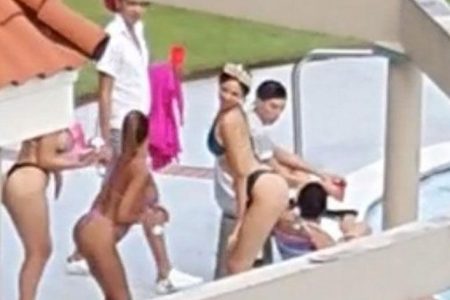 No care for Covid: In this screen grab from video, limers—none of whom are wearing face masks—party at the poolside of Bayside Towers, Cocorite, on Sunday.