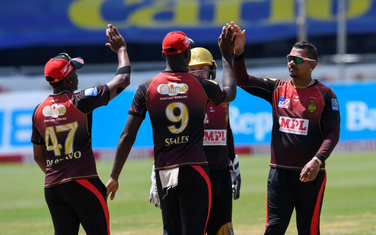 Sunil Narine, right, and Jayden Seales, centre, of Trinbago Knight Riders celebrate the dismissal of Shai Hope of Barbados Tridents during their Caribbean Premier League match at the Brian Lara Cricket Academy in Tarouba, San Fernando on August 23. (Photo by Randy Brooks - CPL T20/Getty Images)