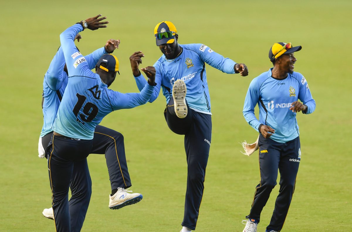Darren Sammy, second right,  and Kaveem Hodge, right, celebrate the dismissal of danger man Andre Russell. (Photo by Randy Brooks-CPLT@) via Getty Images)
