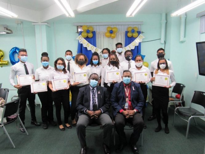 Training Manager  Clifford VanDoimen (sitting at left) and instructor Chandraban Rajnarine (sitting at right) are flanked by the new batch of trainee ATCAs. (GCAA photo)
