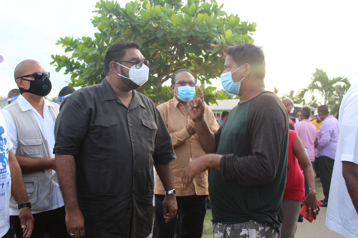 President Irfaan Ali meeting with a resident at Angoy’s Avenue (Bebi Oosman photo)