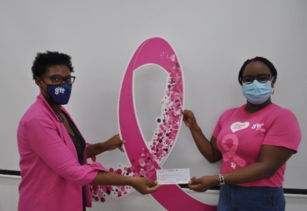 GT&T’s Diana Gittens (left) receives the cheque from GUYOIL’s Lanessa John-Forbes