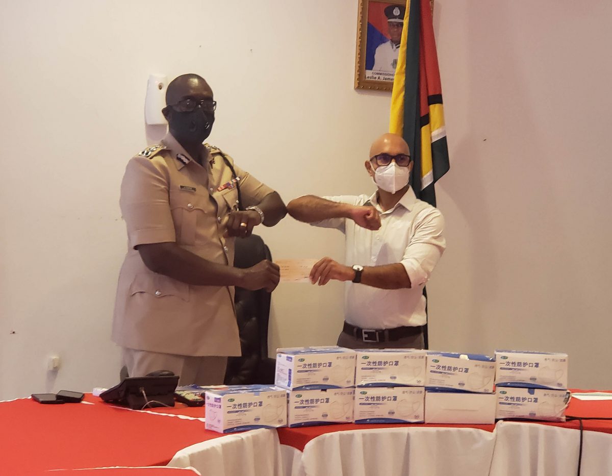 Commissioner of Police Nigel Hoppie receiving the donation from PSC Chairman Nicholas Deygoo-Boyer
