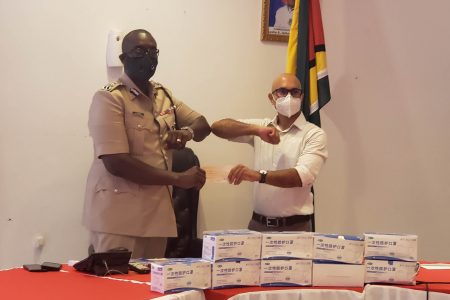 Commissioner of Police Nigel Hoppie receiving the donation from PSC Chairman Nicholas Deygoo-Boyer
