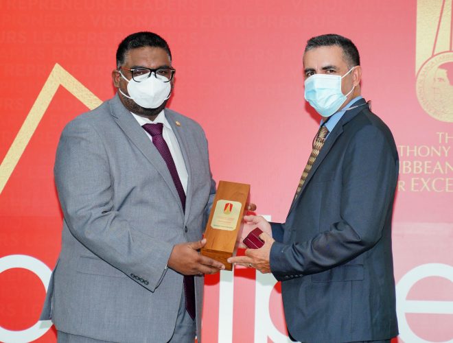 President Irfaan Ali presenting the award to Andrew Mendes yesterday at State House (OP photo)
 