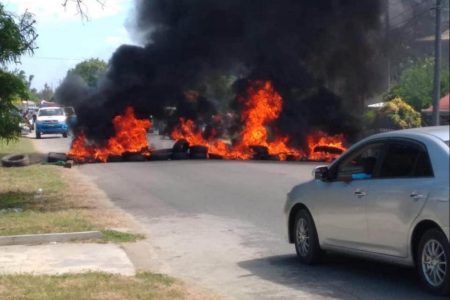 Tyres lit on fire along the public road at No. 3 Village
