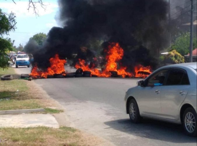 Tyres lit on fire along the public road at No. 3 Village
