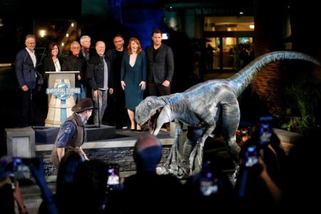 Vice Chairman of Universal Parks & Resorts and President of Universal Creative Mark Woodbury, President and COO of Universal Studios Hollywood Karen Irwin, Vice Chairman of NBCUniversal Ron Meyer, Chairman and CEO of Universal Parks & Resorts Tom Williams, Producer Frank Marshall, Director Colin Trevorrow, Actors Bryce Dallas Howard and Chris Pratt and the velociraptor character named Blue pose at the “Jurassic World - The Ride” grand opening celebration at Universal Studios Hollywood theme park in Universal City, California, U.S., July 22, 2019. (Reuters photo)