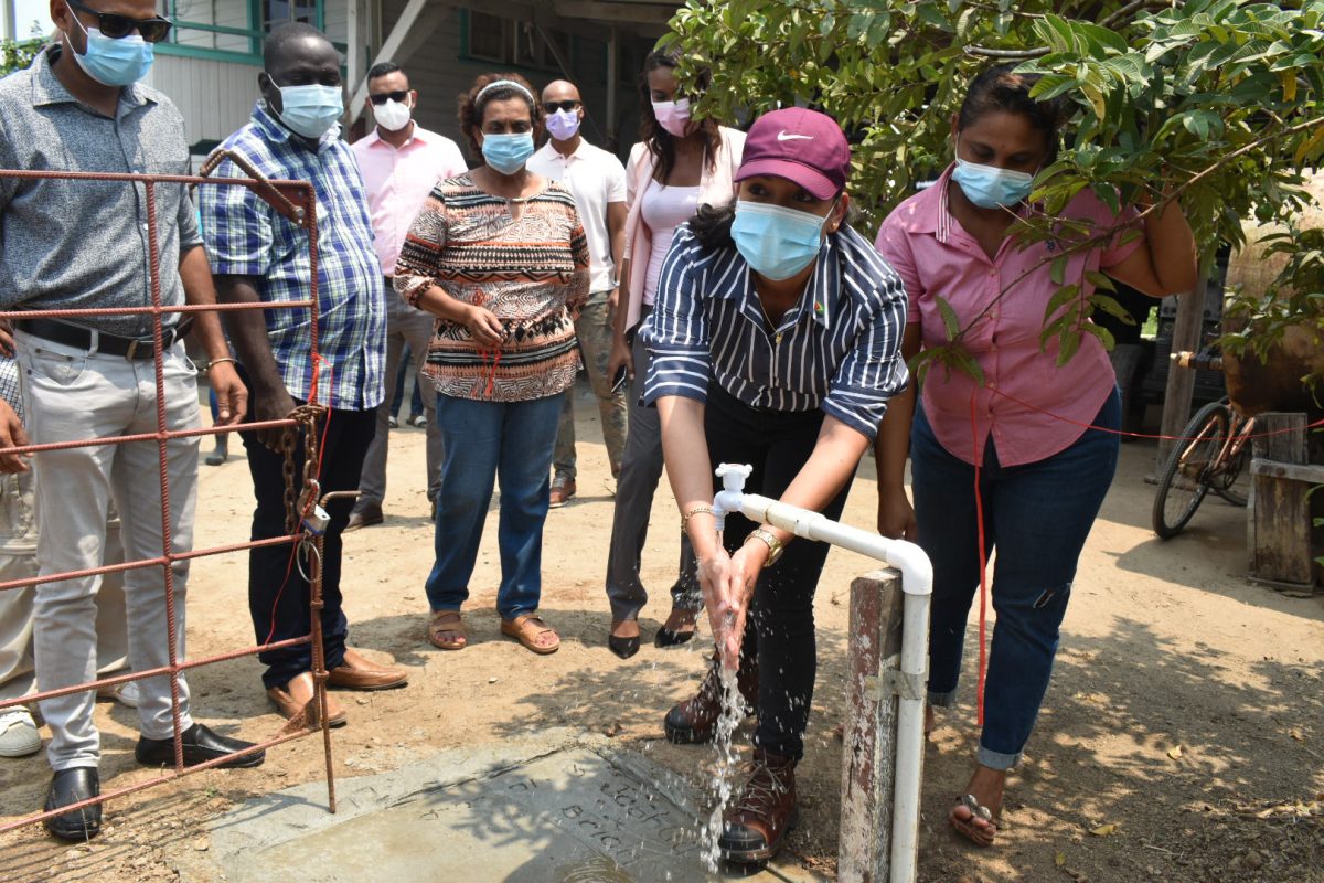 Junior Housing and Water Minister Susan Rodrigues testing the new water supply
