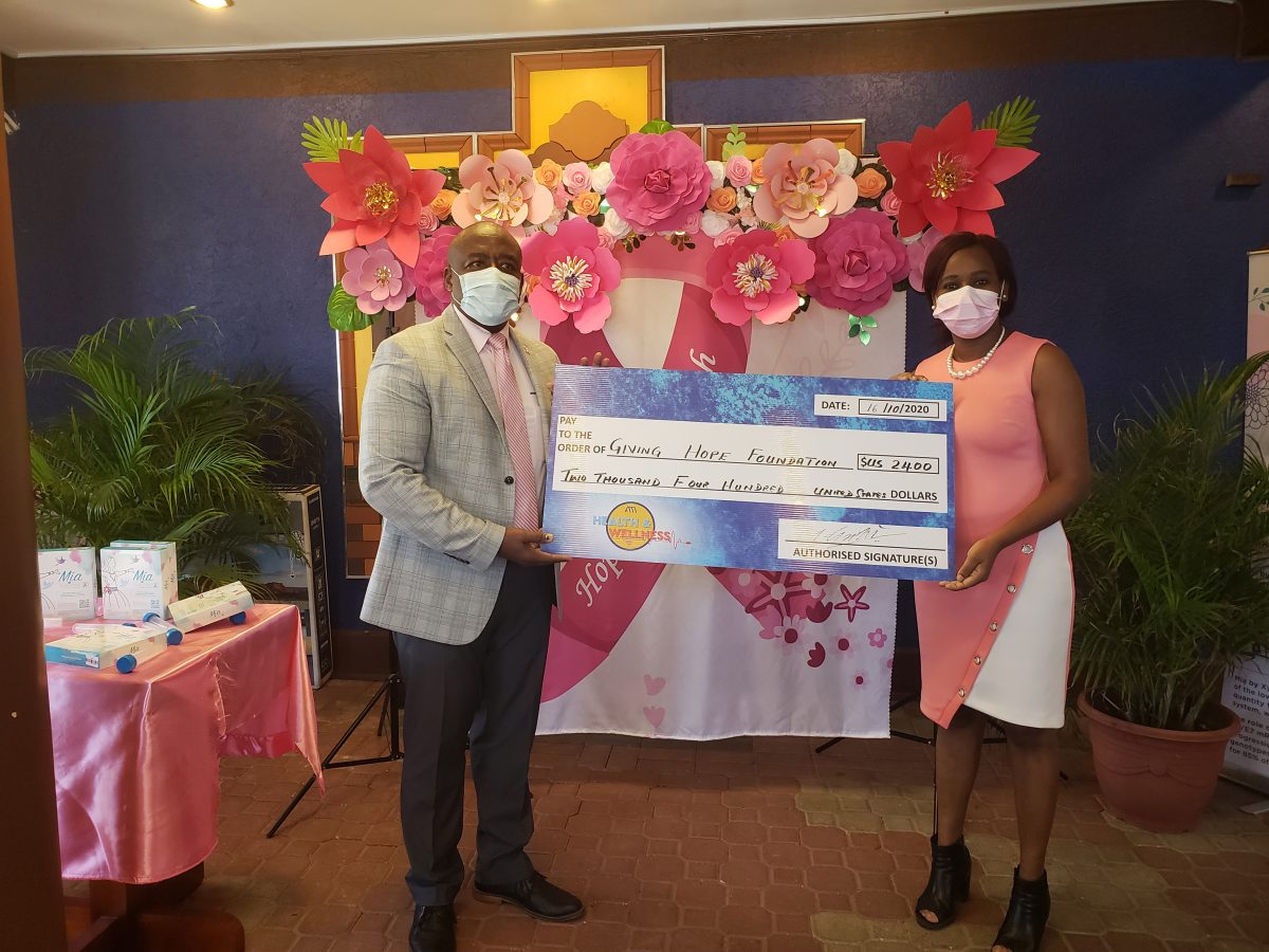 ANSA McAL’s Andrel Griffith handing over the cheque to Dr Latoya Goodings of the Giving Hope Foundation
