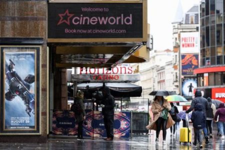FILE PHOTO:  People walk past a Cineworld in Leicester's Square, amid the coronavirus disease (COVID-19) outbreak in London, Britain, October 4, 2020. REUTERS/Henry Nicholls/File photo