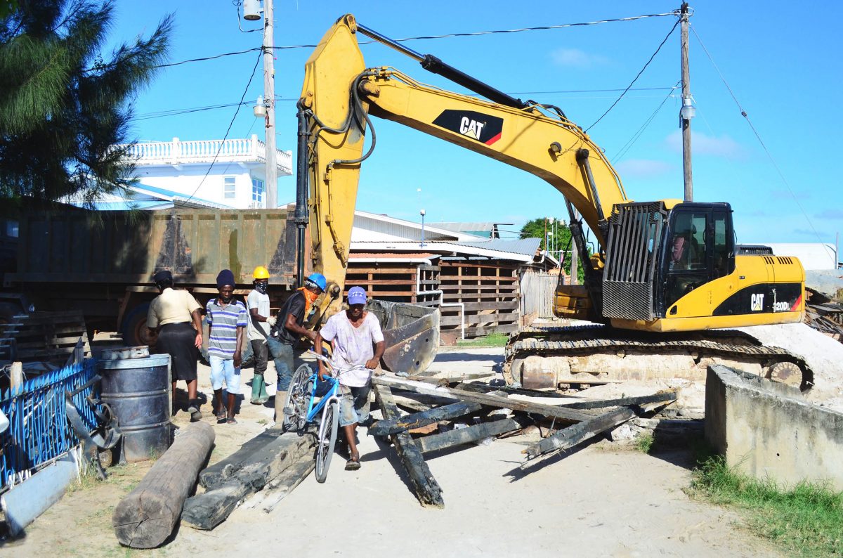 The remnants of a bridge that was used by squatters to access properties at Success, on the East Coast of Demerara, were removed yesterday. (Orlando Charles photo)