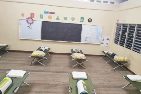 Cots in a classroom at the school (DPI photo)