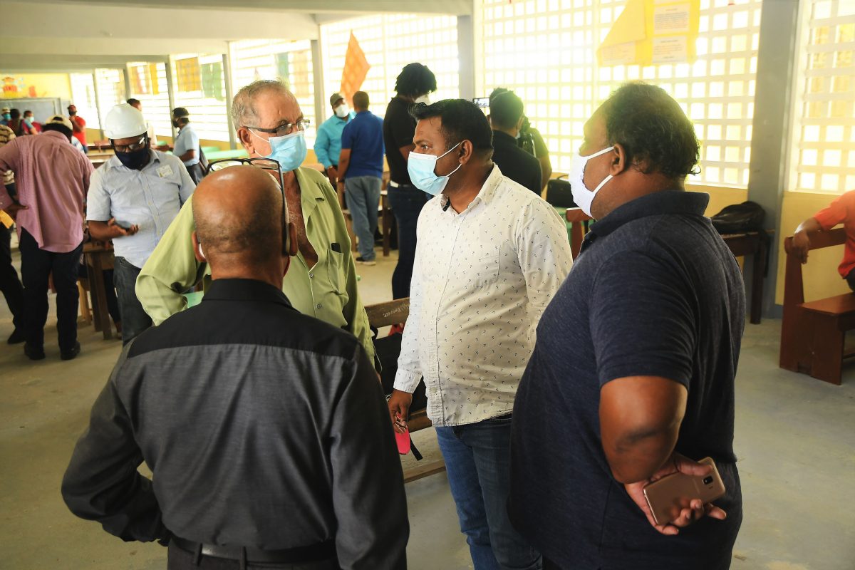 Minister in the Ministry of Public Works, Deodat Indar (second from right) speaking to Wakenaam residents. (Ministry of Public Works photo)