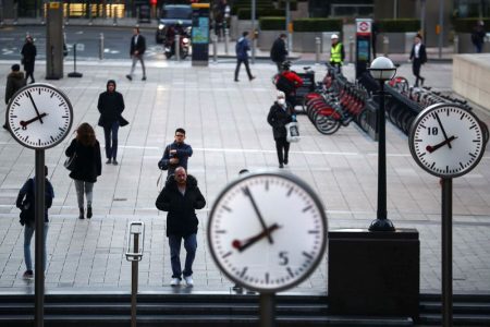 People walk during the morning rush hour in the Canary Wharf amid the outbreak of the coronavirus disease (COVID-19) in London Britain, October 15, 2020. REUTERS/Hannah McKay