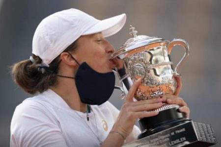 Iga Swiatek (POL) kisses the trophy after her match against Sofia Kenin (USA) on day 14 at Stade Roland Garros. Mandatory Credit: Susan Mullane-USA TODAY Sports.
