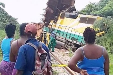 Curious onlookers view the derailed train. The driver is reportedly okay after the crash.
