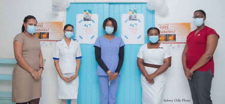 The health care providers at the Diabetic Eye Centre at the Enmore polyclinic pose for a photo in front of the centre (Aubrey Odle photo)