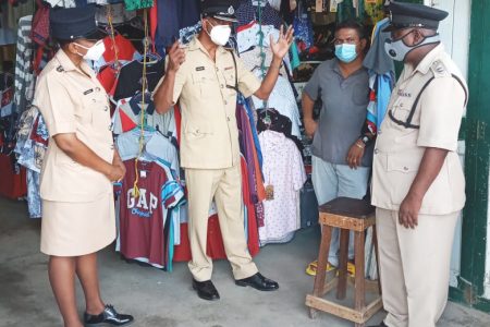 Region Six Police Commander Jairam Ramlakhan (second from left) and other ranks interacting with a vendor at the Corriverton Market

