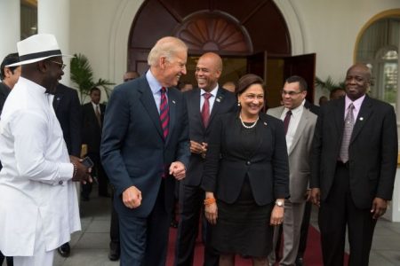 Vice-President Joe Biden walks with then-Prime MInister Kamla Persad-Bissessar and President Michel Martelly of Haiti, after meeting at the Diplomatic Centre in Port-of-Spain on May 28, 2013.