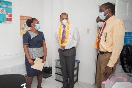  A health care worker (at left) showing Minister of Health Dr Frank Anthony; Permanent Secretary Malcolm Watkins and Regional Executive Officer Dwight John an examination room at the new Bamia Health Centre (DPI photo) 