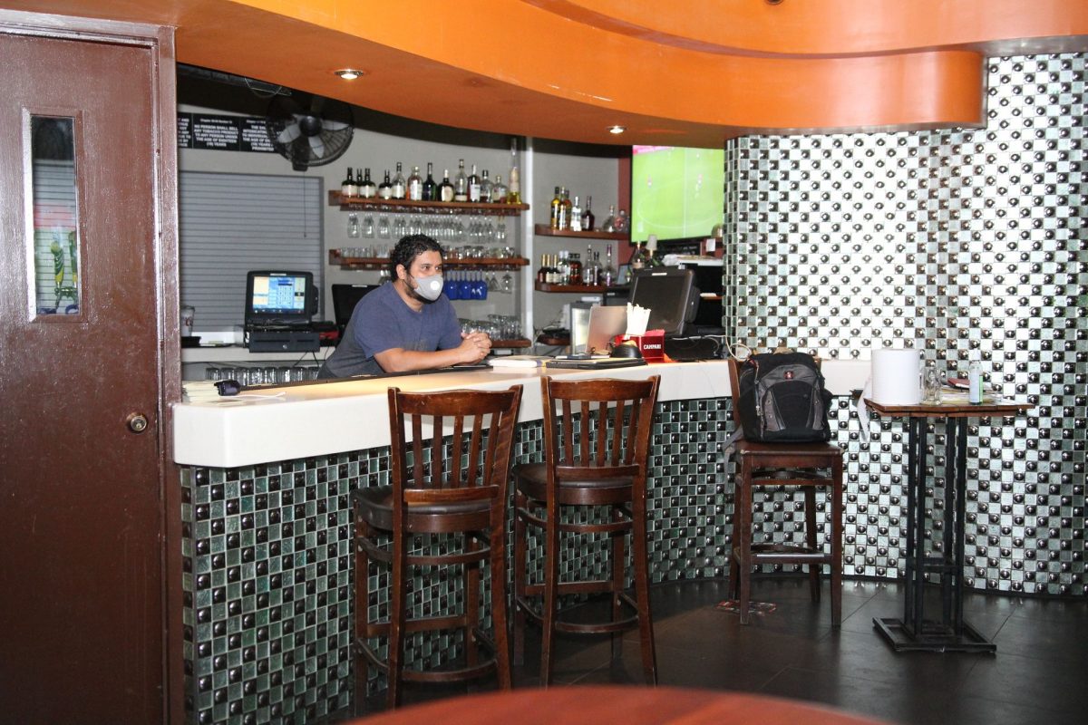 A bartender waits on customers at the The Avenue Pub House on Ariapita Avenue, Woodbrook, Port-of-Spain.