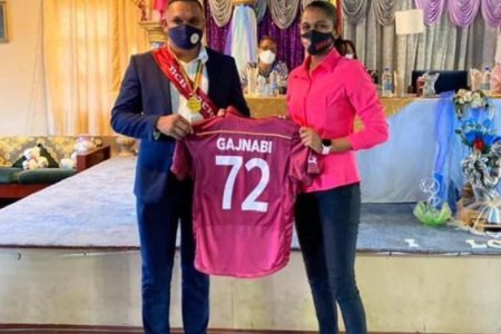 Minister of Natural Resources, Vickram Bharrat (left) poses for a photo after being sworn in as the first ever Honorary Patron of the Berbice Cricket Board along with West Indies female all-rounder, Shabika Gajnabi.