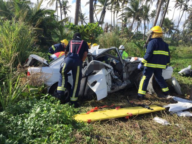 Fire officers at the crash site on the Manzanilla stretch in which Sacha Surujbally, 21, and her three-month baby Syriah died yesterday.