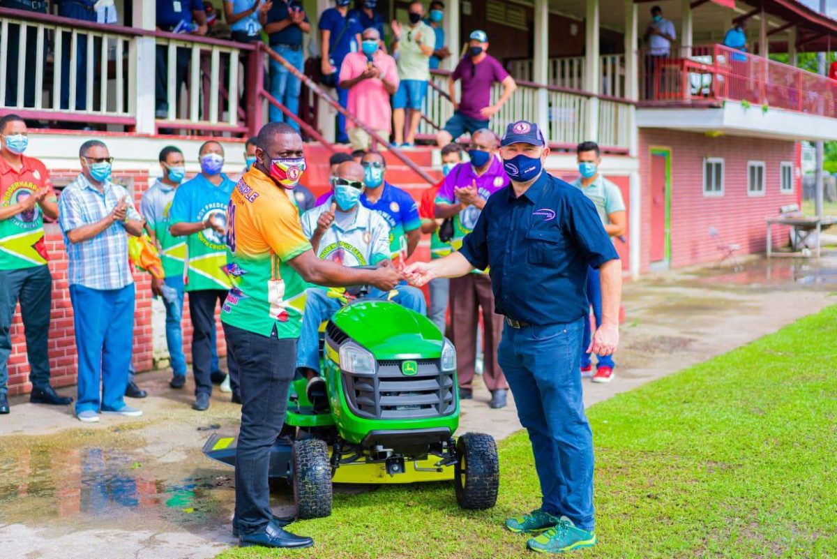 The spanking new lawn-mower being handed over to DCC’s acting president Lawrence Smith. 
 