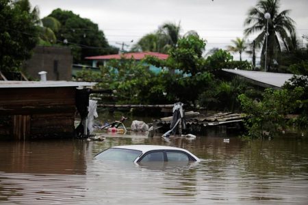 A submerged car is pictured at a flooded street during the passage of Storm Eta, in La Lima, Honduras November 5, 2020. REUTERS/Jorge Cabrera