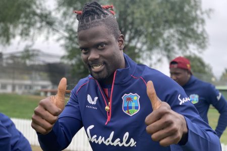 West Indies player Andre Fletcher gives the thumbs up sign after the West Indies players successfully passed a second Covid-19 test