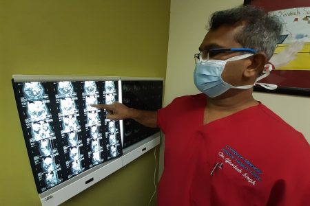 Advanced Laparoscopic Surgeon Dr Yardesh Singh shows a CT scan at his office at Southern Medical Clinic, San Fernando.