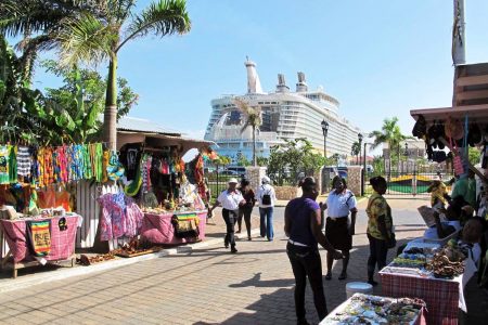 In this September 26, 2012 photo, the Royal Caribbean’s Allure of the Seas cruise ship is docked in Falmouth, Trelawny, as vendors prepare to sell clothes, souvenirs and other goods to tourists.
