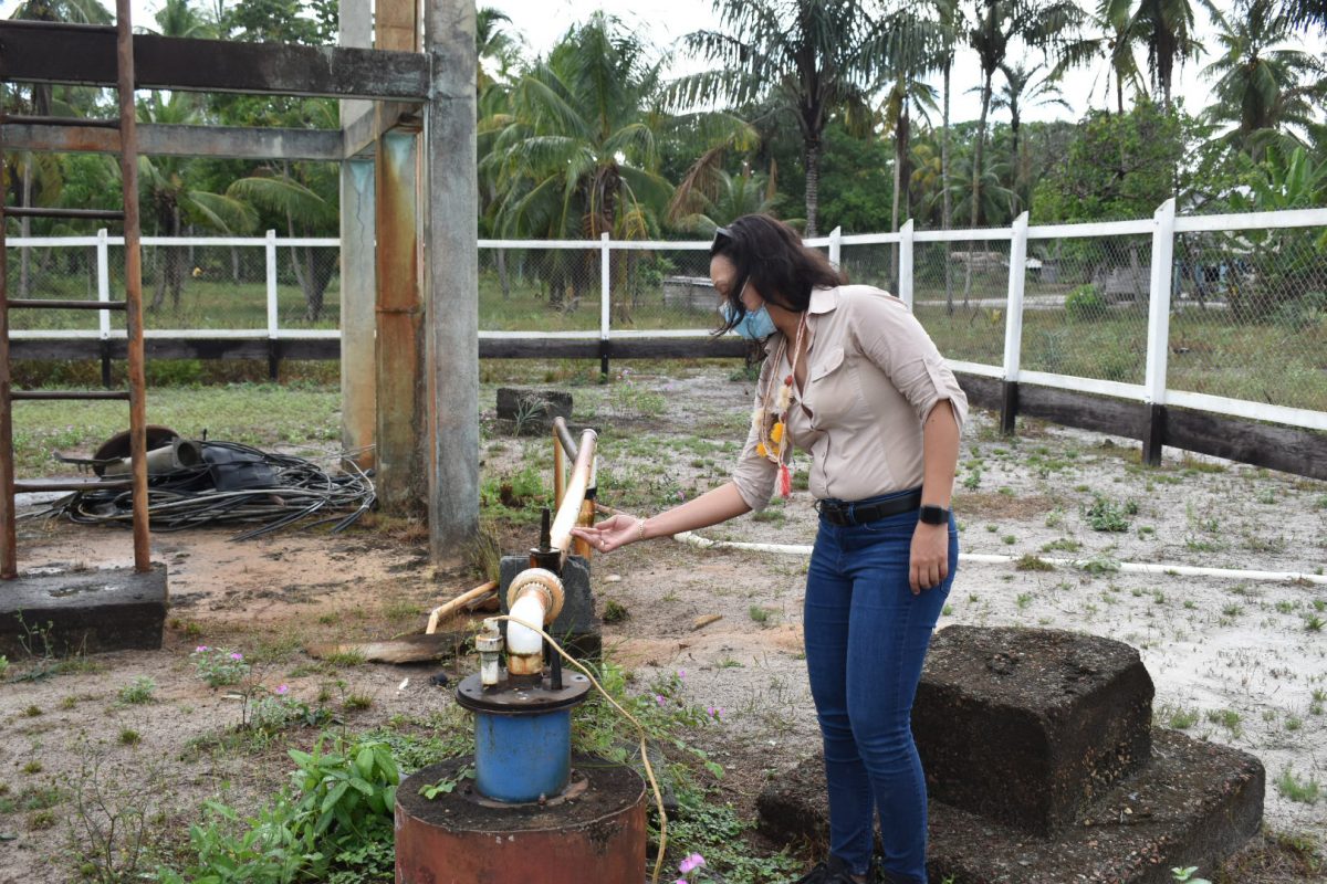 Minister within the Ministry of Housing & Water, Susan Rodrigues checking the water supply system in the village (GWI photo)