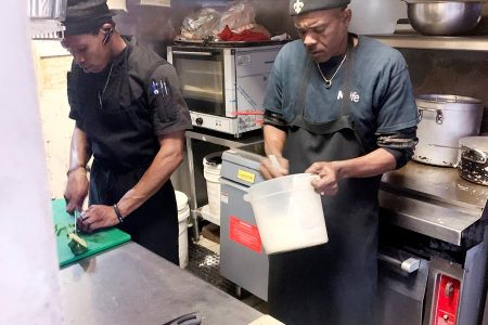 Chefs in the kitchen at Coastline Caribbean Restaurant in Gulfport, Mississipi, in the United States.
