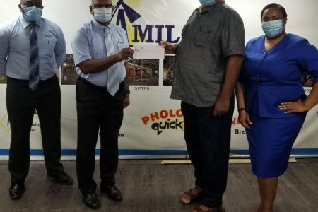 RHTYSC Hilbert Foster receives the sponsorship from Namilco Managing Director Bert Sukhai in the presence of company officials Fitroy Mcleod and Alicia Anderson.
