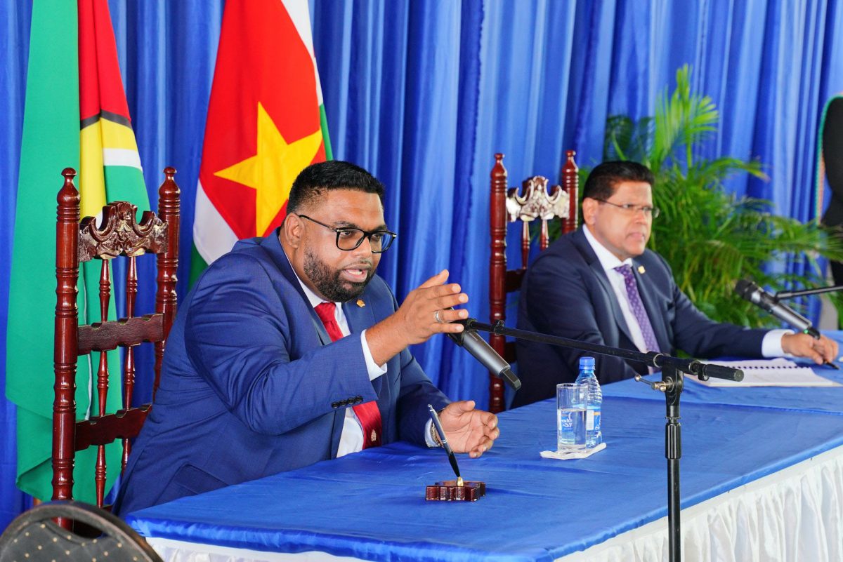 President Irfaan Ali (left) and Surinamese President Chan Santokhi at yesterday’s press conference in Paramaribo on a MoU for the Corentyne River Bridge and other matters. (Office of the President photo)