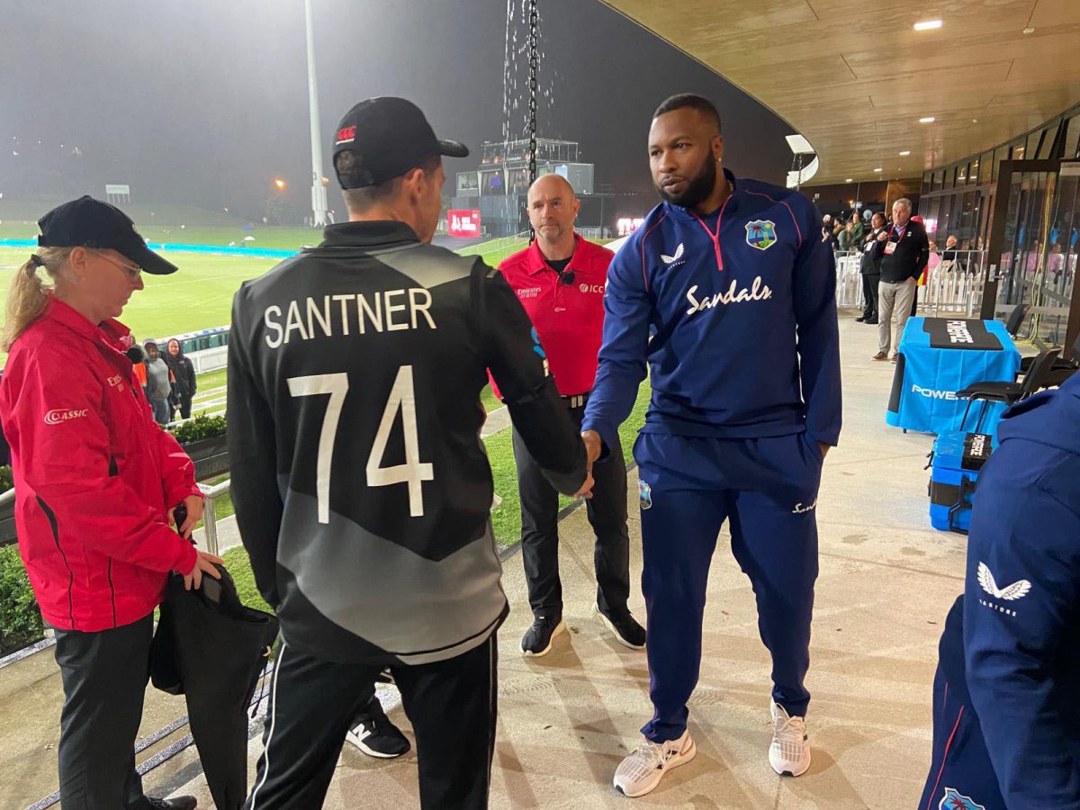 New Zealand captain Mitchell Santner and West Indies captain Kieron Pollard shake hands, after the final T20I of their sides’ three-match series ended in a no-result because of rain yesterday at the Bay Oval in Mount Maunganui, New Zealand. (NZC photo)
