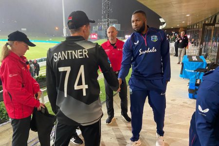 New Zealand captain Mitchell Santner and West Indies captain Kieron Pollard shake hands, after the final T20I of their sides’ three-match series ended in a no-result because of rain yesterday at the Bay Oval in Mount Maunganui, New Zealand. (NZC photo)
