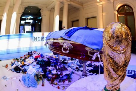 A replica of the World Cup Trophy stands next to the casket of soccer legend Diego Maradona at the presidential palace Casa Rosada, in Buenos Aires, Argentina November 26, 2020. Argentina Presidency/Handout via Reuters