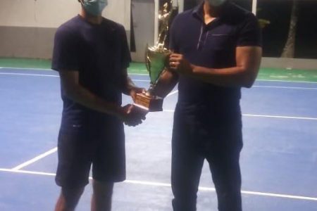 Heimraj Resaul receives his championship cup from Minister of Culture, Youth and Sport, Charles Ramson Jr.
