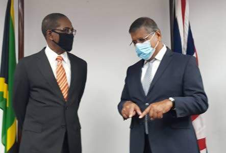 Chairman of the Integrity Commission Justice (Ret’d) Seymour Panton (left) and British High Commissioner to Jamaica Asif Ahmad discuss a J$108m gift from the Government of the United Kingdom to aid in Jamaica’s fight against corruption. 