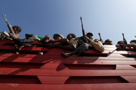 FILE PHOTO: Members of Amhara region militias ride on their truck as they head to the mission to face the Tigray People's Liberation Front (TPLF), in Sanja, Amhara region near a border with Tigray, Ethiopia November 9, 2020. REUTERS/Tiksa Negeri